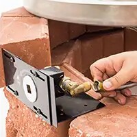 placing a paver block bracket control valve on a layer of stone