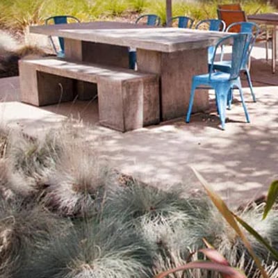 Rooftop lounge area before the renovation featuring a large concrete table