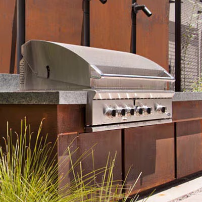 DCS gas grill built into granite countertops of outdoor kitchen