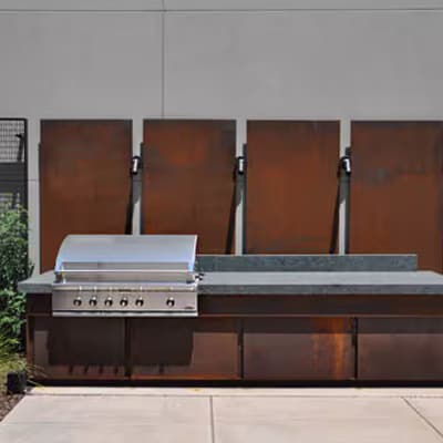 Full Outdoor kitchen island featuring luxury steel cabinets and backsplash