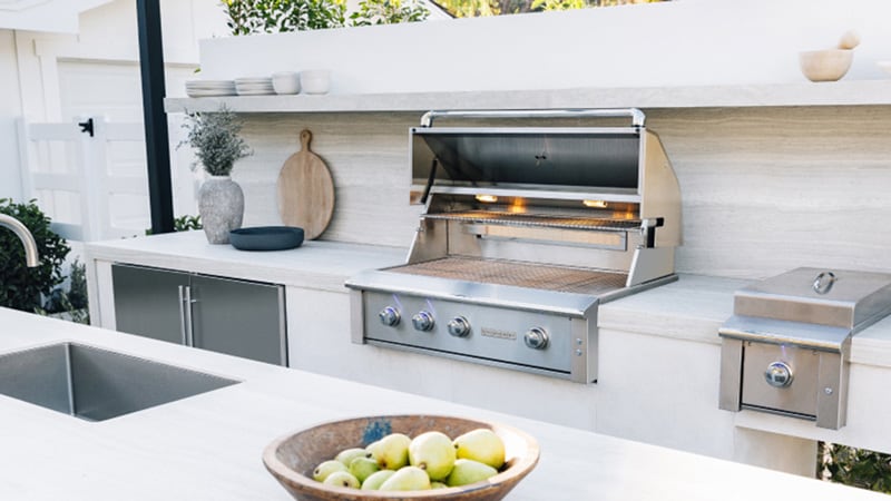 Modern white outdoor kitchen featuring Summerset Grills